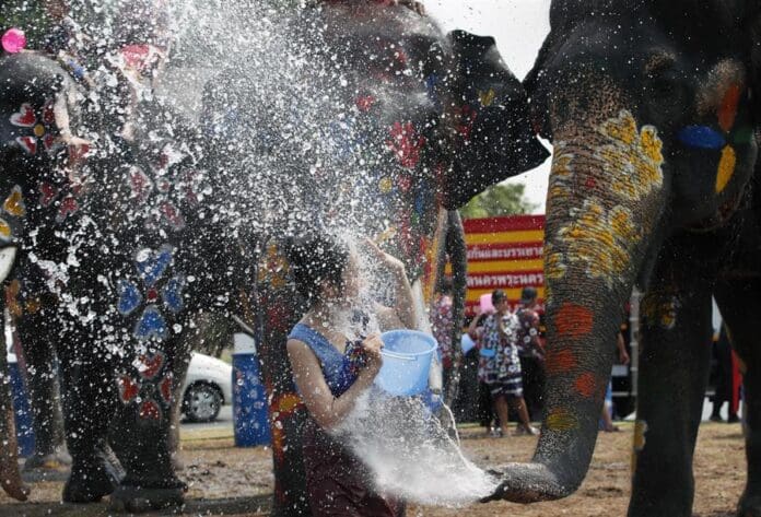 (FILE) An elephant splashes a woman with water during a preview of the Songkran Festival celebration, also known as the Water Festival, in the historic city of Ayutthaya, the ancient capital, Thailand, 09 April 2024. EFE/EPA/RUNGROJ YONGRIT
