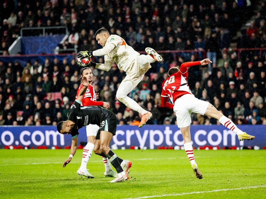 Cody Gakpo (L) of Liverpool FC and PSV Eindhoven goalkeeper Walter Benitez (up) in action during the UEFA Champions League match between PSV Eindhoven and Liverpool FC at Phillips Stadium in Eindhoven, Netherlands, Jan 29, 2025. EFE/EPA/Robin van Lonkhuijsen