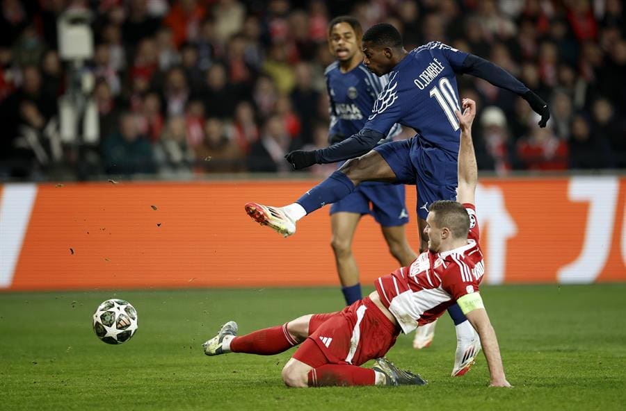 Ousmane Dembele of PSG shoots to score his team's third goal against Brest captain Brendan Chardonnet during the UEFA Champions League knockout phase play-offs 1st leg match between Stade Brest and Paris Saint-Germain, in Guingamp, France, 11 February 2025. EFE/EPA/YOAN VALAT