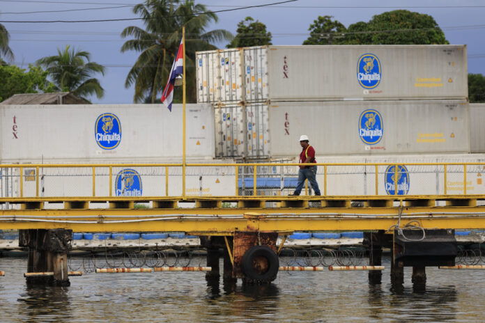 A man walks in front of containers of the banana company Chiquita on Tuesday, in Puerto Almirante, Panama. Jun. 18, 2025. EFE/ Bienvenido Velasco