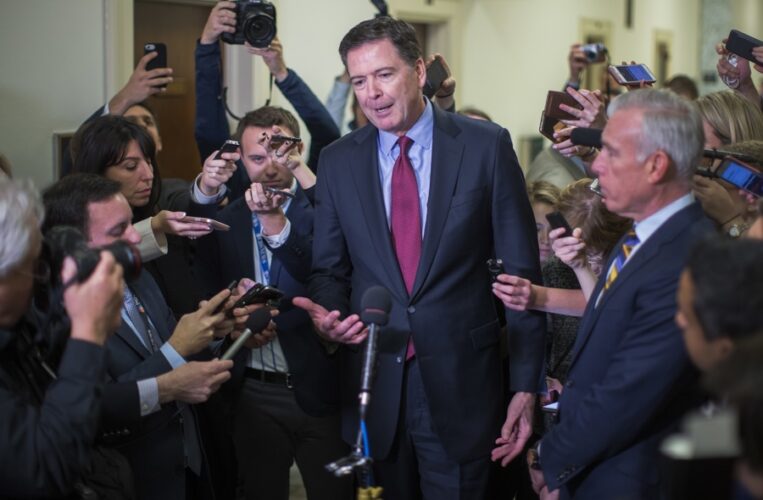 FILE). File photo, taken on December 7, 2018, shows former FBI Director James Comey (center) speaking to reporters after a hearing in Washington, DC. December 07, 2018. EFE/EPA/ERIK S. LESSER. FILE