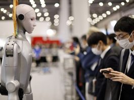 AI Japanese Robots Update! A visitor stands next to a humanoid robot at the TechShare booth during the International Robot Exhibition 2025 (iREX2025) in Tokyo, Japan, 03 December 2025. EFE/EPA/FRANCK ROBICHON