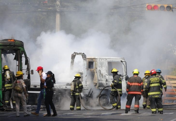 Members of the Guadalajara Fire Department attempt to extinguish a burning vehicle on Feb. 22, 2026 in Guadalajara, Mexico. EFE/ Francisco Guasco