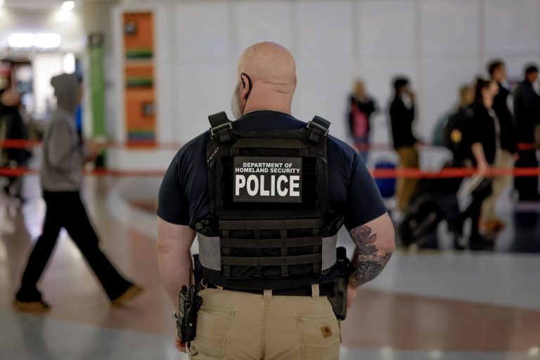 A Department of Homeland Security federal police officer stands watch as air passengers wait in long security screening lines to pass through a Transportation Security Administration (TSA) checkpoint at HartsfieldJackson Atlanta International Airport in Atlanta, Georgia, US, 19 March 2026. EFE/EPA/ERIK S. LESSER