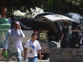 People approach the hearse carrying the remains of Nemesio Oceguera Cervantes, alias "El Mencho," leader of the Jalisco New Generation Cartel (CJNG), upon its arrival at the Recinto de la Paz cemetery in Zapopan, Jalisco, Mexico, on Mar. 2, 2026. EFE/ Francisco Guasco