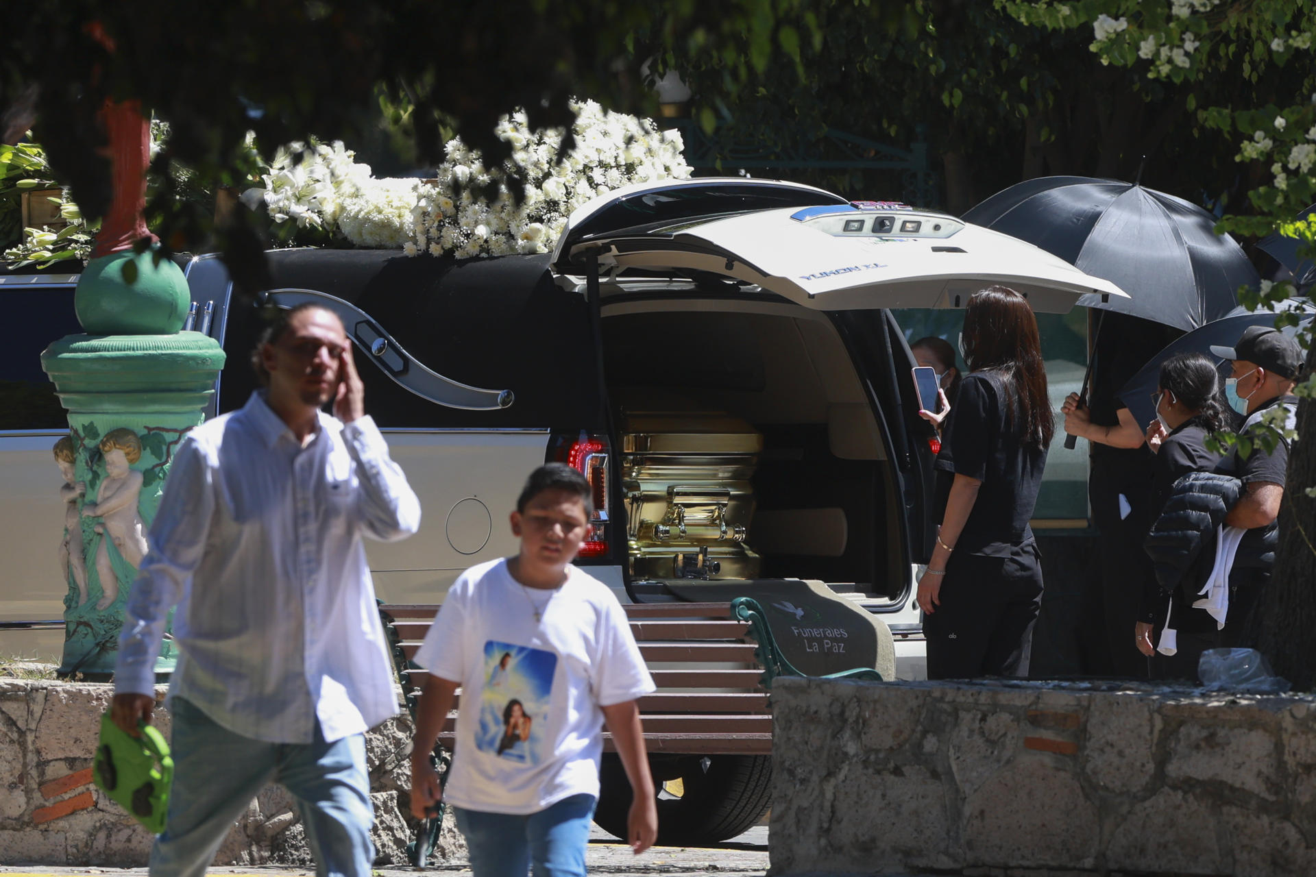 People approach the hearse carrying the remains of Nemesio Oceguera Cervantes, alias "El Mencho," leader of the Jalisco New Generation Cartel (CJNG), upon its arrival at the Recinto de la Paz cemetery in Zapopan, Jalisco, Mexico, on Mar. 2, 2026. EFE/ Francisco Guasco
