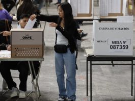 Peru votes for 9th President in 10 years! A Peruvian voter (C) residing in Barcelona casts her ballot for Peruvian general election at the polling station set up at Monjuic convention center, in Barcelona, northeastern Spain, 12 April 2026. EFE/EPA/Toni Albir