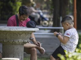 A child uses a mobile phone at a park in Denpasar, Bali, Indonesia, 28 March 2026. EFE-EPA/MADE NAGI