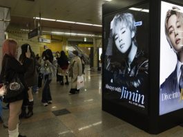 Fans take a pictures with band member Jimin's ad as they gather to see a concert of K-pop group BTS, also known as ARMY, in Goyang, northwest of Seoul, South Korea, 09 April 2026, where BTS is kicking off its new world tour 'Arirang.' EFE/EPA/JEON HEON-KYUN