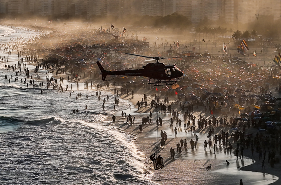 In this file photo, a maritime firefighters helicopter carries out a rescue on Leme beach, Rio de Janeiro (Brazil) during a heat wave. EFE/Antonio Lacerda