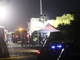 (FILE) Police and officials man a roadblock near a tractor trailor on the side of the road leading to the location where at least 46 migrants were reportedly found dead along with at least 15 who were still alive, on a roadway near railroad tracks in San Antonio, Texas, USA, June 28, 2022. EFE/EPA/ADAM DAVIS