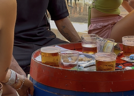 Young people have beers at a bar in Malaga. Free time, tourism, the heat, and holidays are some of the factors that experts link to increased alcohol consumption during the summer, a time when risks increase and the perception of them decreases. EFE/Victoria Coronas