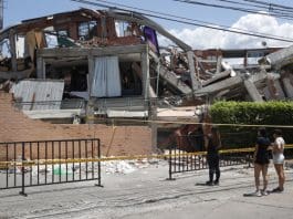 A group of women look at the rubble of a building that was destroyed by Thursday's 7.4-magnitude earthquake in Cali, Colombia. Aug. 13, 2026. EFE/ Ernesto Guzmán