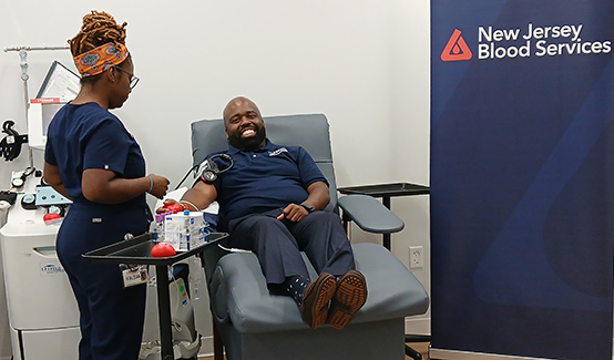 Freehold, NJ. Phlebotomist Nalisha Jackson preparing to draw blood from Dr. Raynard E. Washington, Commissioner of the New Jersey Department of Health (NJDOH). Photo by Oscar Quintana